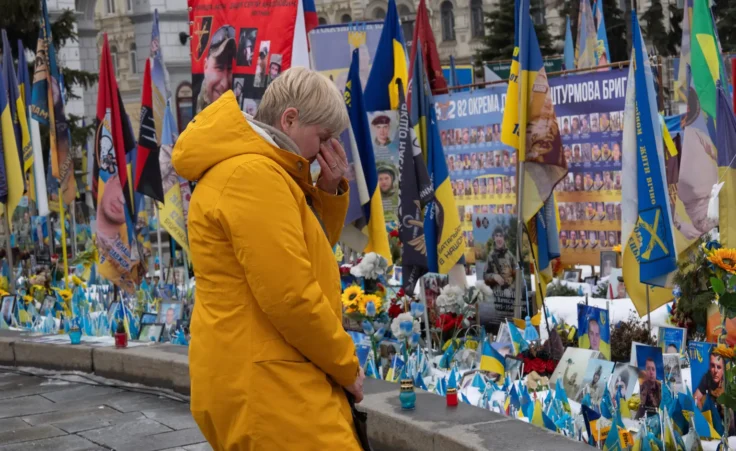 A woman reacts at the memorial to the fallen Ukrainian soldiers on Independence Square on the fourth anniversary of Russia's full-scale invasion in Kyiv, Ukraine, Tuesday, Feb. 24, 2026. (AP Photo/Efrem Lukatsky)