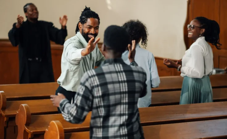 Group of friends celebrating faith inside a church by Zamrznuti tonovi/stock.adobe.com