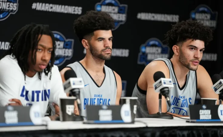Duke forward Cameron Boozer, right, speaks as Duke guards Cayden Boozer, center, and Isaiah Evans, left, look on during a press conference ahead of a game against UConn in the Elite Eight of the NCAA college basketball tournament Saturday, March 28, 2026, in Washington. (AP Photo/Abbie Parr)