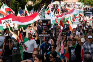 A large crowd of demonstrators gather near the Federal Building in the Westwood area to celebrate and call for freedom for the Iranian people in the wake of U.S.-Israel attacks on Iran that killed Iran's Supreme Leader Ayatollah Ali Khamenei on March 1, 2026 in Los Angeles, California. (Photo by Qian Weizhong/VCG via AP )