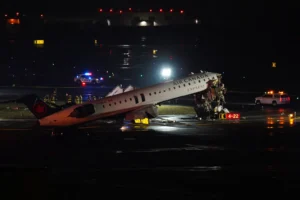 An Air Canada Jet sits on the runway at LaGuardia Airport, Monday, March 23, 2026, after colliding with a Port Authority aircraft rescue and firefighting vehicle in New York. (AP Photo/Ryan Murphy)