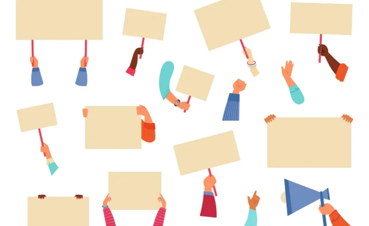 Hands holding placards and blank protest signs. By MicroOne/adobe.stock.com.