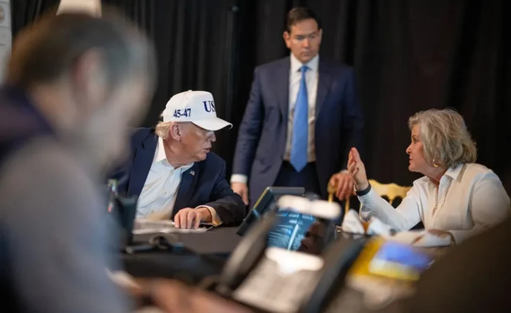 This photo provided by the White House which has been partially blurred, shows President Donald Trump talking with White House chief of staff Susie Wiles as Secretary of State Marco Rubio listens at Mar-a-Lago in Palm Beach, Fla., during Operation Epic Fury on Saturday, Feb. 28, 2026. (Daniel Torok/The White House via AP)