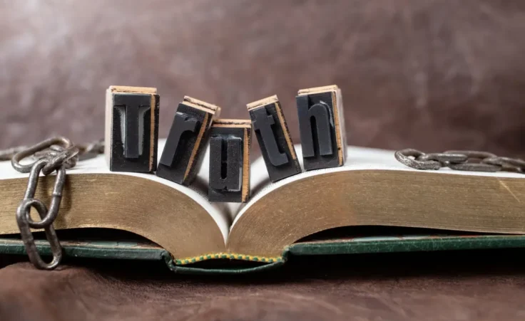 truth will set you free, still life concept with golden book and broken chains, soft focus close up By Dorin/stock.adobe.com