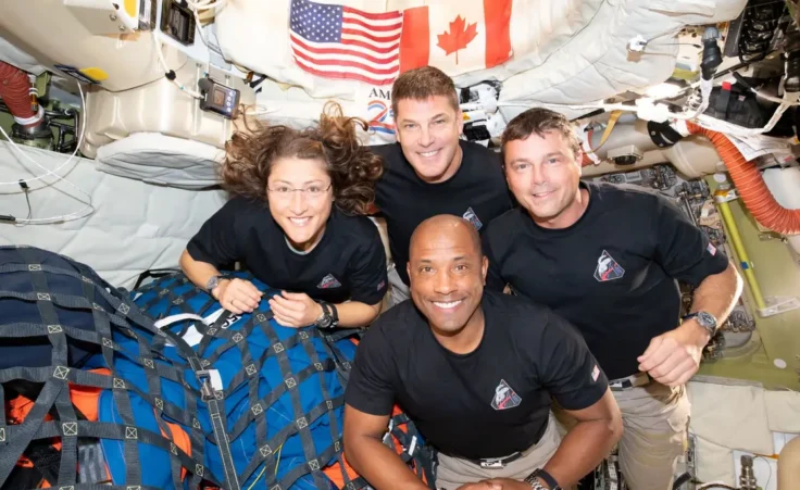 In this image provided by NASA, the Artemis II crew, clockwise from left, Mission Specialist Christina Koch, Mission Specialist Jeremy Hansen, Commander Reid Wiseman, and Pilot Victor Glover, pause for a group photo inside the Orion spacecraft on their way home on Wednesday, April 7, 2026. (NASA via AP)