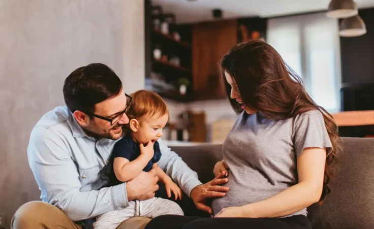 Happy family at home excited about expecting new baby By djile/stock.adobe.com