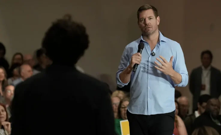 California gubernatorial candidate, Rep. Eric Swalwell, D-CA answers a question from University of California, Davis, student, Patrick Mason, during a town hall meeting in Sacramento, Calif., Tuesday, April 7, 2026. (AP Photo/Rich Pedroncelli)