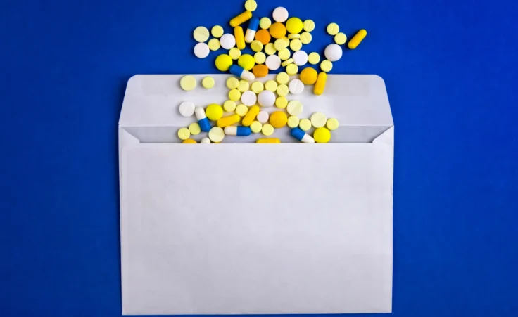 Pills in an envelope. By Sabphoto/stock.adobe.com. abortion pill