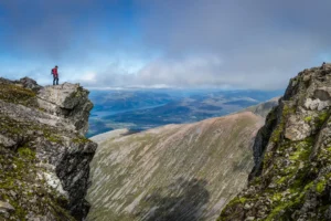 Man overlooking the vista on Ben Nevis mountain in Scotland. By Brian/stock.adobe.com. Three peaks challenge dad climbs mountain