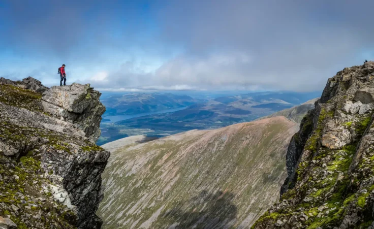 Man overlooking the vista on Ben Nevis mountain in Scotland. By Brian/stock.adobe.com. Three peaks challenge dad climbs mountain