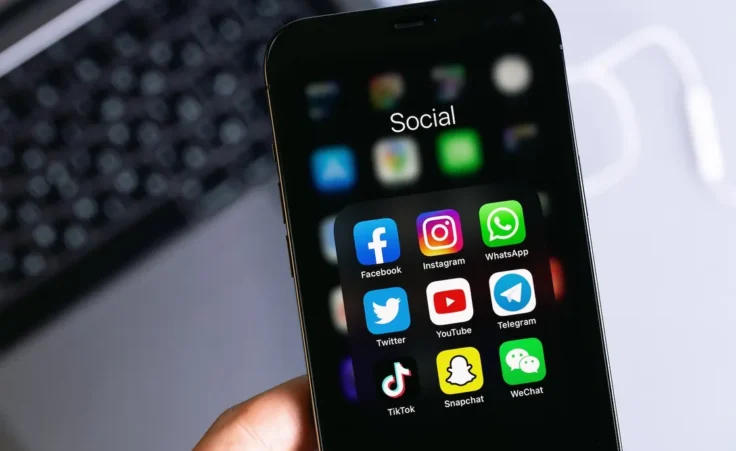showing social media mobile apps (Facebook, Instagram, WhatsApp, Twitter, YouTube, Telegram, TikTok, Snapchat) on screen macro interface smartphone iPhone in hand. Moscow, Russia - January 16, 2021/stock.adobe.com