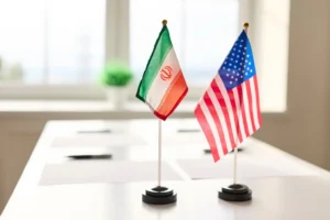 Stock image of diplomacy flags for the nations of Iran and the United States. By StudioRomantic/stock.adobe.com. Iran US America peace deal Switzerland