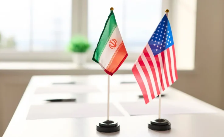Stock image of diplomacy flags for the nations of Iran and the United States. By StudioRomantic/stock.adobe.com. Iran US America peace deal Switzerland