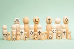 Wooden people with symbols of different religious beliefs: Christianity, Islam, Hinduism, Buddhism, and Judaism. By BeritKessler/stock.adobe.com. america religion