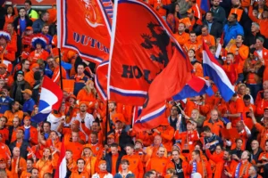 Dutch fans clad in the traditional orange colors of the team wave flags prior to the World Cup Group A qualifying soccer match in the ArenA stadium in Amsterdam, Netherlands, Monday, Oct. 10, 2016. (AP Photo/Peter Dejong)