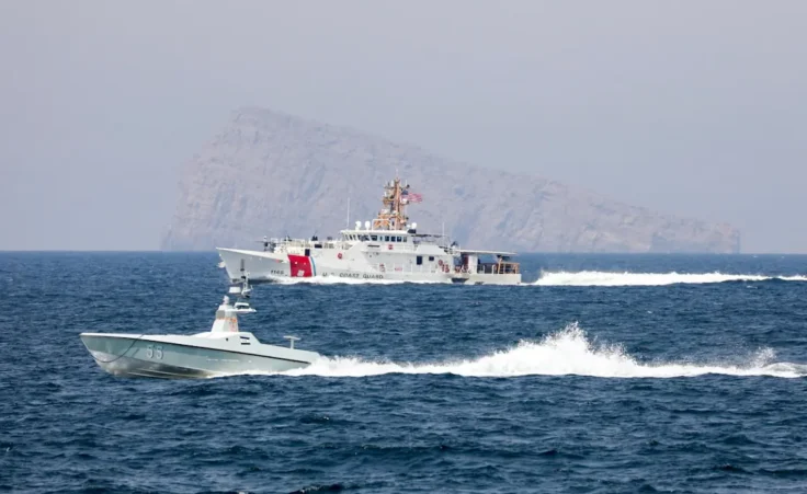 A U.S. Navy L3 Harris Arabian Fox MAST-13 drone boat and the U.S. Coast Guard cutter USCGC John Scheuerman transit the Strait of Hormuz on Wednesday, April 19, 2023. The U.S. Navy sailed its first drone boat through the strategic Strait of Hormuz on Wednesday, a crucial waterway for global energy supplies where American sailors often faces tense encounters with Iranian forces. (Information Systems Technician 1st Class Vincent Aguirre/U.S. Coast Guard via AP)