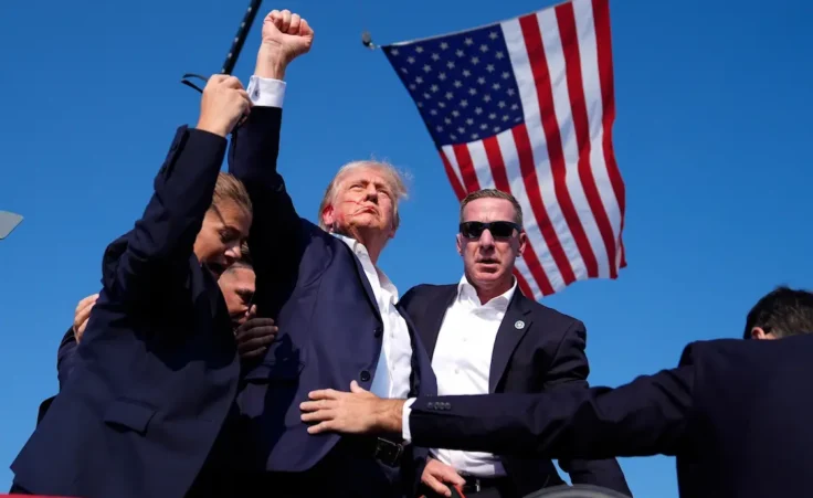 FILE - Republican presidential candidate former President Donald Trump is surrounded by U.S. Secret Service agents after being shot at a campaign rally, July 13, 2024, in Butler, Pa. (AP Photo/Evan Vucci, File)